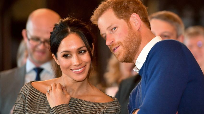 CARDIFF, WALES - JANUARY 18:  Prince Harry whispers to Meghan Markle as they watch a dance performance by Jukebox Collective in the banqueting hall during a visit to Cardiff Castle on January 18, 2018 in Cardiff, Wales. (Photo by Ben Birchall - WPA Pool / Getty Images)