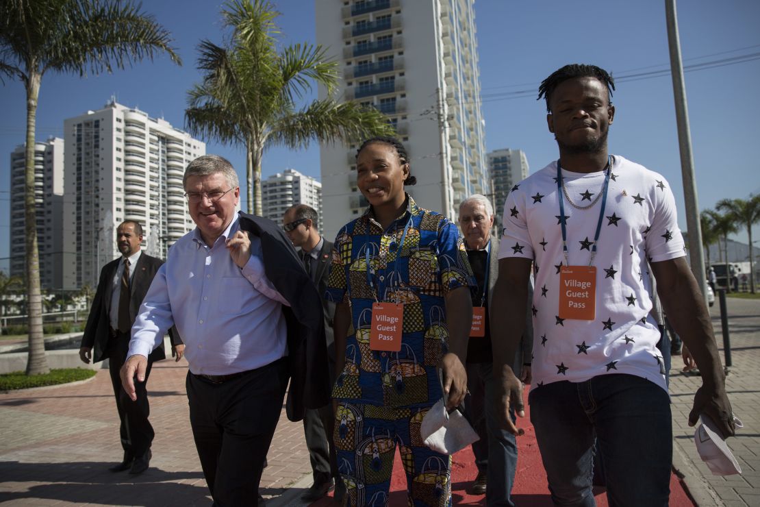 Mabika and Misenga walk alongside IOC President Thomas Bach.