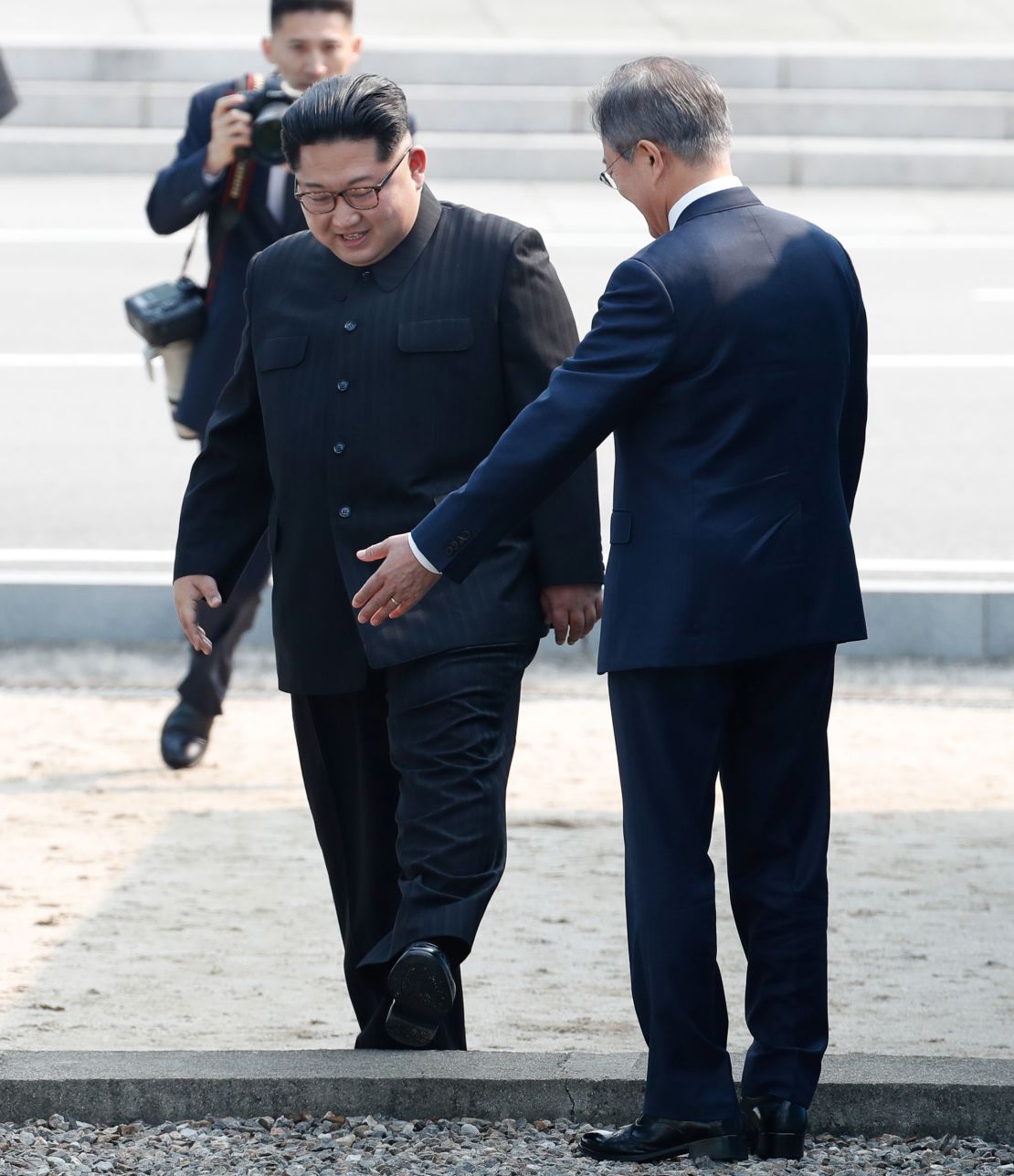  North Korean leader Kim Jong Un, left, crosses the border upon meeting with South Korean President Moon Jae-in, right, for the summit Friday.