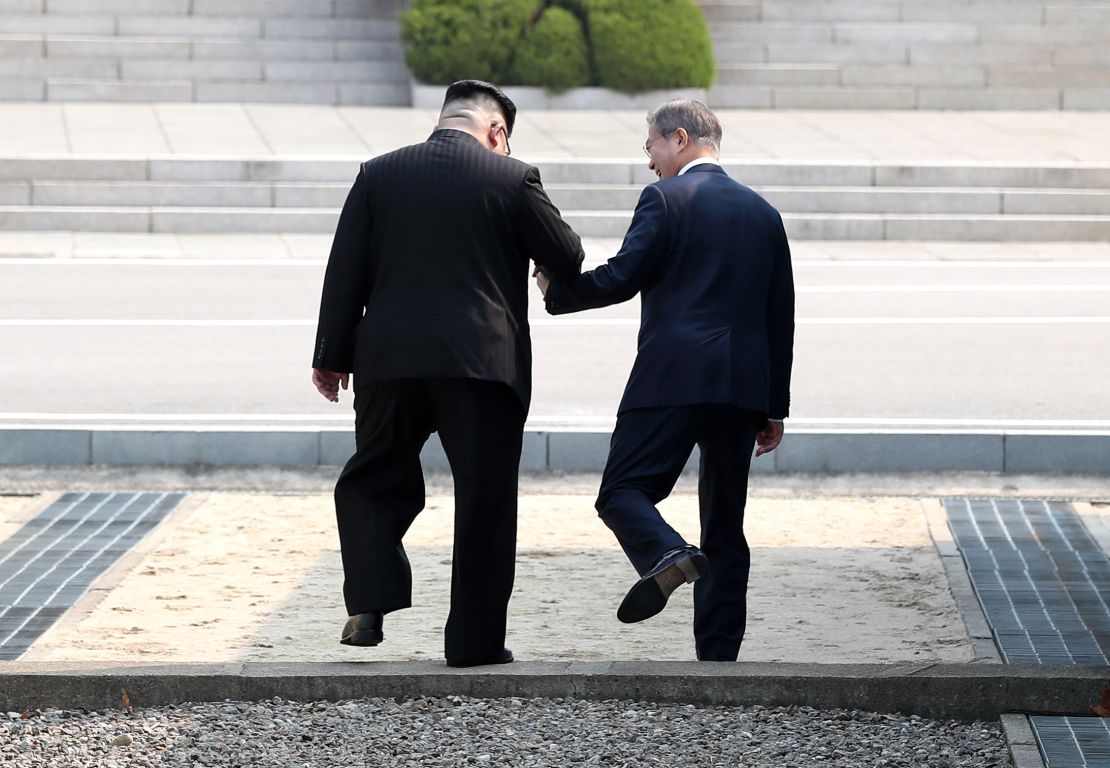 North Korean leader Kim Jong Un invites South Korean President Moon Jae-in to step into North Korea with him at their April summit.