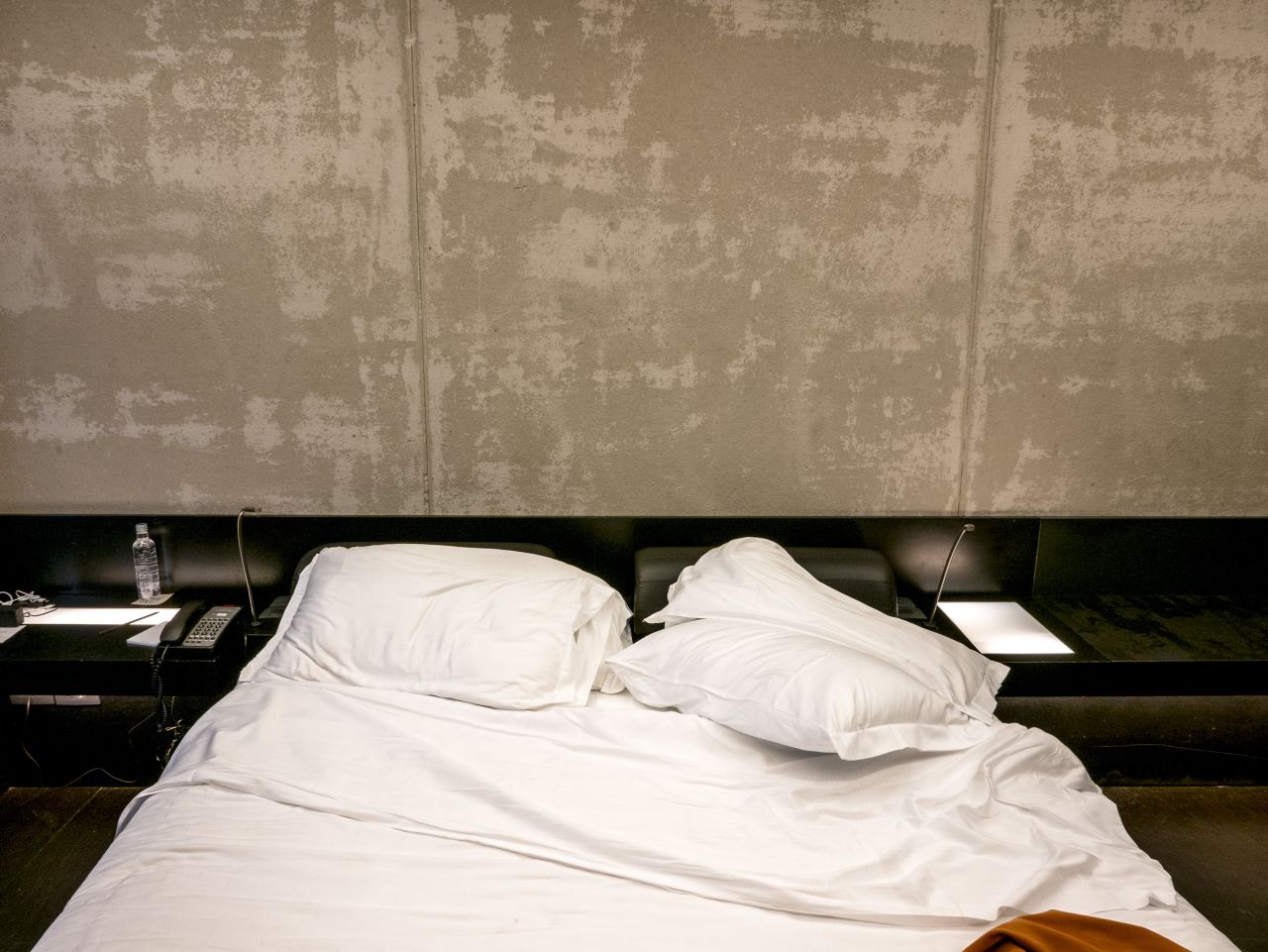 At first it is hard to see much difference, but then details emerge -- imprints on a bed showing which side a guest slept on; a bedside lamp left on; pillows rumpled, tossed to the floor or neatly stacked. 