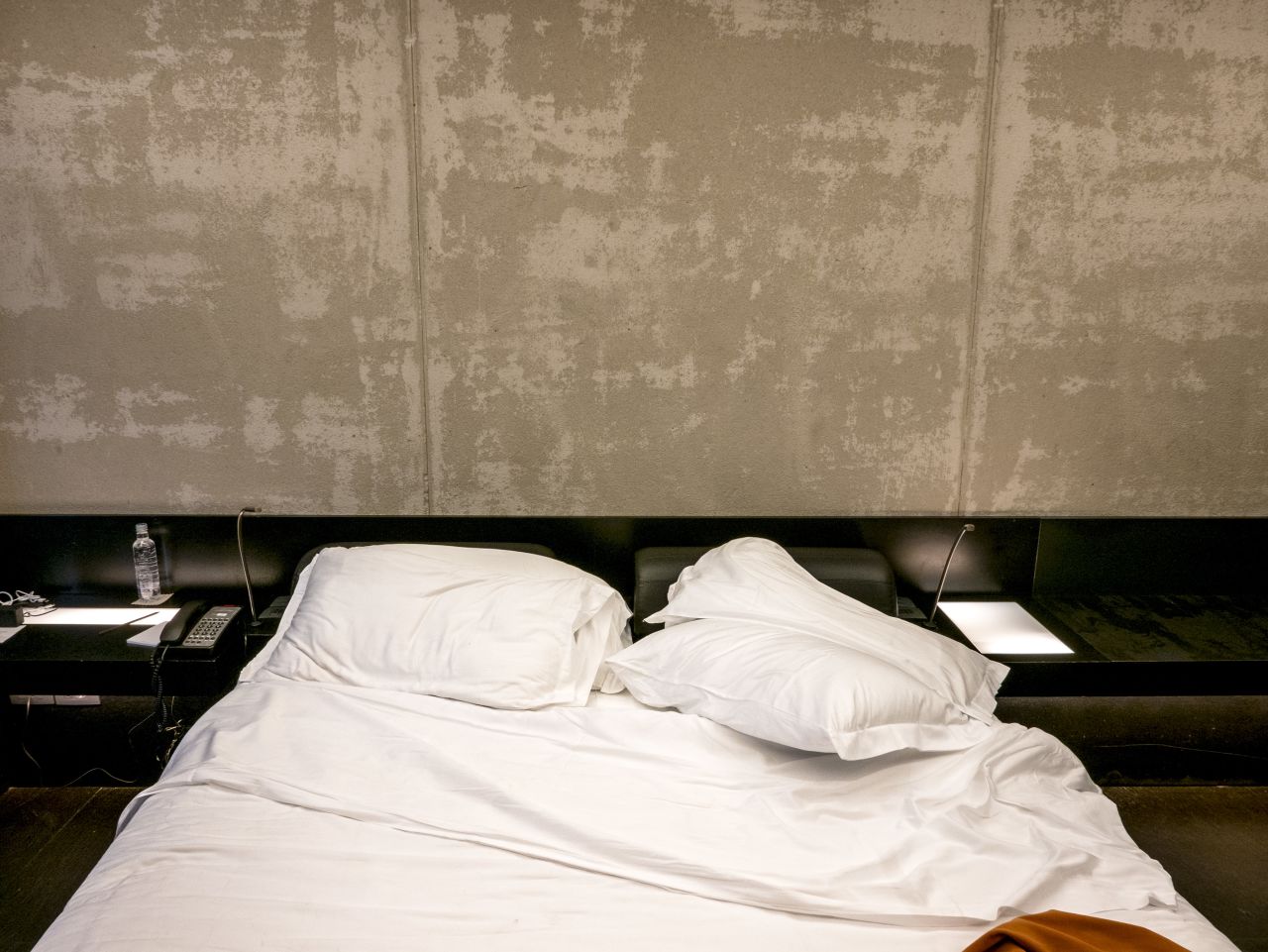 At first it is hard to see much difference, but then details emerge -- imprints on a bed showing which side a guest slept on; a bedside lamp left on; pillows rumpled, tossed to the floor or neatly stacked.