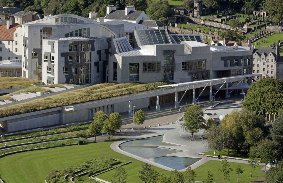 The vision of Catalan architect Enric Miralles, the Scottish Parliament building, in the Holyrood area of Edinburgh, controversially introduced postmodern design close to the ancient buildings of the Royal Mile and Holyrood Palace.  
