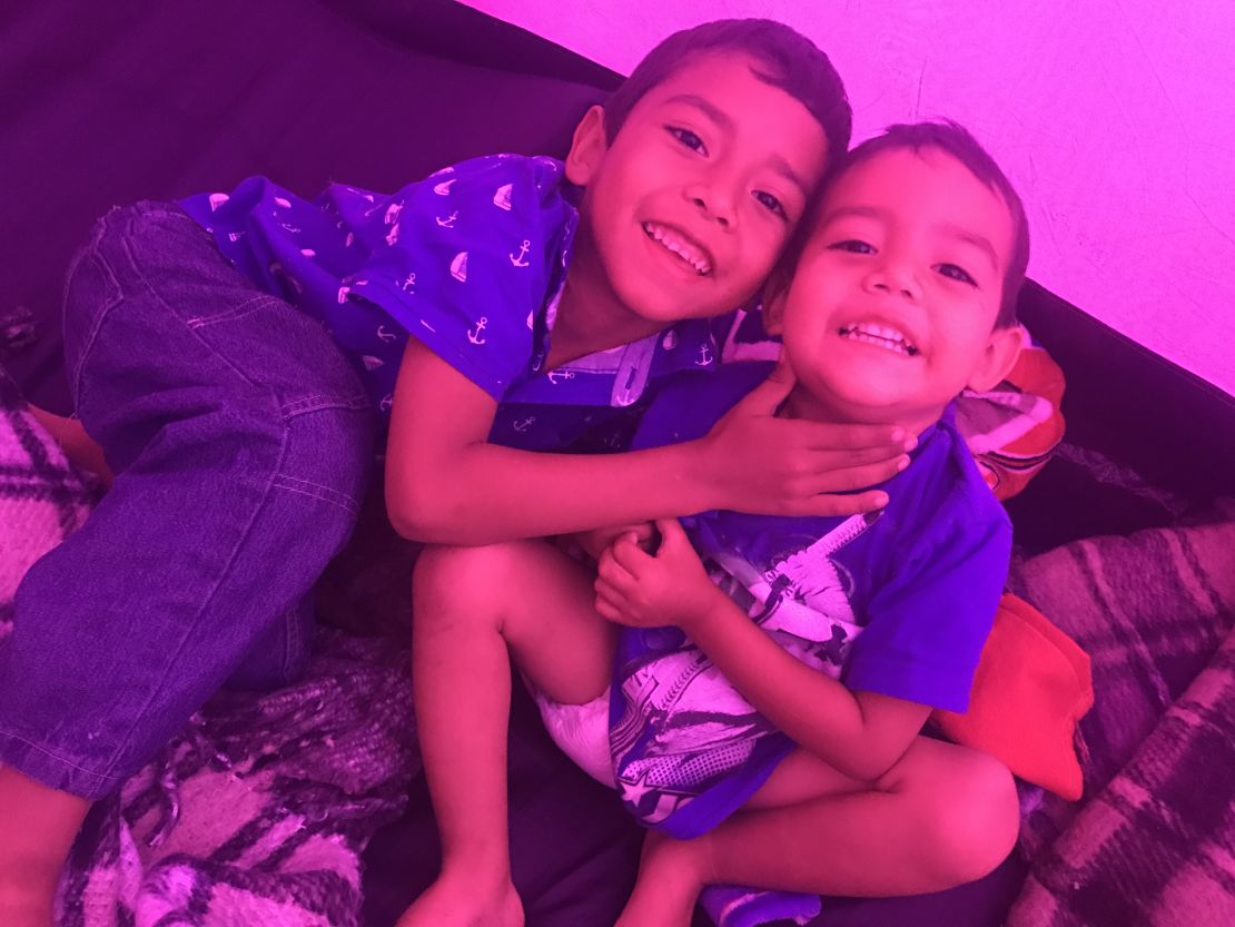 The boys play inside their fuchsia tent, a little space of their own for a while.