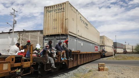 Migrants find what space they can on freight trains. 