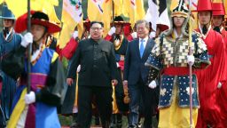 North Korea's leader Kim Jong Un (L) walks with South Korea's President Moon Jae-in (R) down a red carpet during a welcoming ceremony to the official summit Peace House building ahead of their meeting at Panmunjom on April 27, 2018. - North Korean leader Kim Jong Un and the South's President Moon Jae-in sat down to a historic summit Friday after shaking hands over the Military Demarcation Line that divides their countries in a gesture laden with symbolism. (Photo by Korea Summit Press Pool / Korea Summit Press Pool / AFP)        (Photo credit should read KOREA SUMMIT PRESS POOL/AFP/Getty Images)