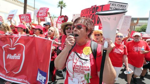 PHOENIX, AZ - APRIL 26:  Educator Kelley Fisher leads Arizona teachers through downtown Phoenix on their way to the State Capitol during a rally for the #REDforED movement on April 26, 2018 in Phoenix, Arizona. Teachers state-wide staged a walkout strike on Thursday in support of better wages and state funding for public schools.  (Photo by Ralph Freso/Getty Images)