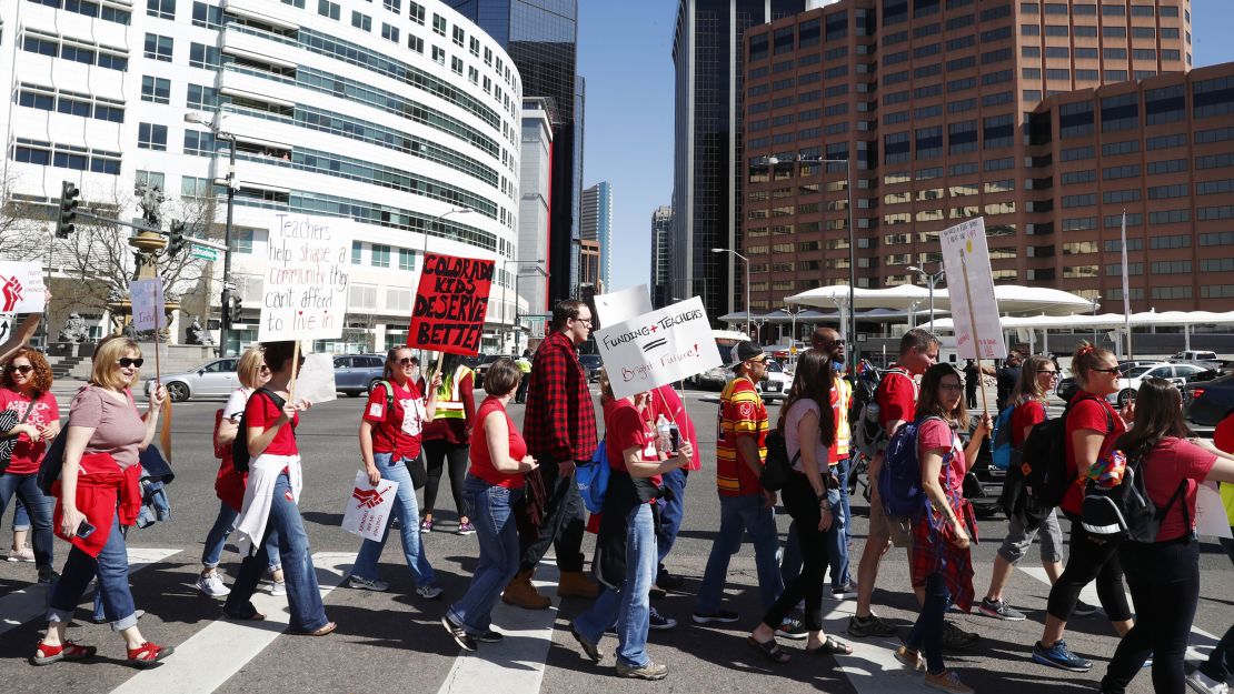 Teachers march on  Broadway in Denver on Friday. 