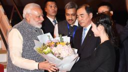 Indian Prime Minister Narendra Modi (L) receives a bunch of flowers after arriving in Wuhan in China's central Hubei province on April 27, 2018. - Chinese President Xi Jinping and Indian Prime Minister Narendra Modi will seek to repair strained ties at a summit on April 27 after an intense border dispute marred relations last year. (Photo by - / AFP) / China OUT        (Photo credit should read -/AFP/Getty Images)