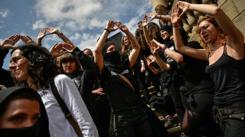Masked women protest Saturday in Pamplona against sexual abuse.