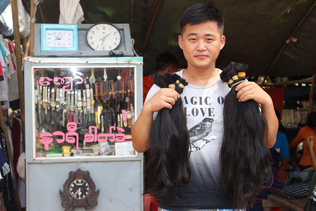 A hair buyer from China with bunches of hair he has bought from Yangon's Insein market. 