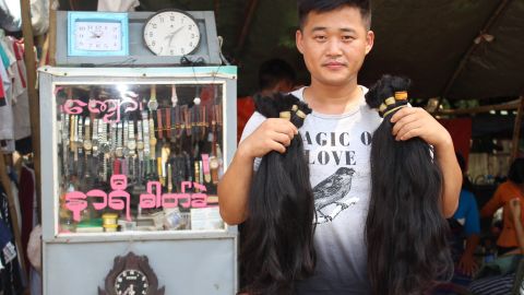 A hair buyer from China with bunches of hair he has bought from Yangon's Insein market. 