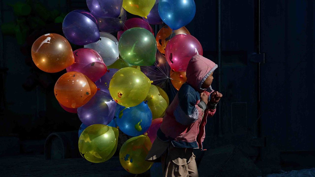 An Afghan boy sells balloons in Kabul in 2013.