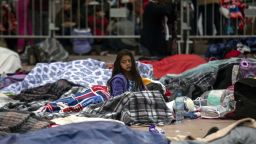 Central American migrants  sleep outside a port of entry  Monday in Tijuana while waiting to be received by US authorities.