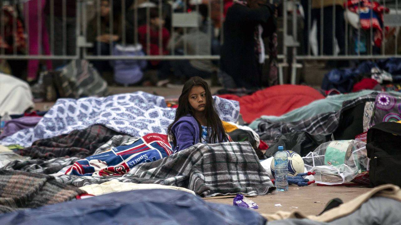 A young girl, part of the caravan of Central American asylum seekers who recently reached the US border, camps outside a port of entry in Tijuana, Mexico. 