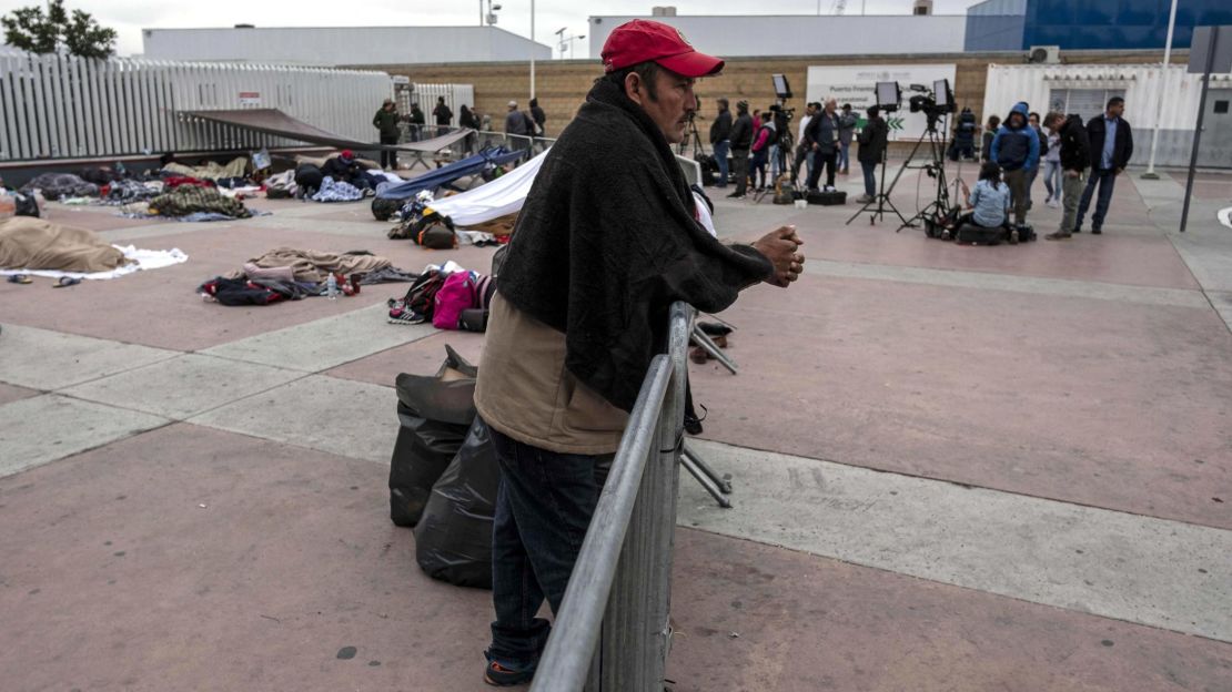 A Central American migrant   waits to be received by US authorities outside "El Chaparral" port of entry in Tijuana.