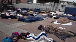 Central American migrants travelling in the "Migrant Via Crucis" caravan sleep outside "El Chaparral" port of entry to US while waiting to be received by US authorities, in Tijuana, Baja California State, Mexico on April 30, 2018. - According to the U.S. Customs and Border Protection on Sunday, none of the migrants from the caravan was processed for asylum because the agency had reached capacity for the day for migrants seeking asylum. At least 150 Central American migrants reached the border between Mexico and the United States on Sunday, determined to seek asylum from the US. The group arrived in the Mexican border town of Tijuana, part of a caravan of more than 1,000 people who set out from Mexico's southern border on March 25. (Photo by GUILLERMO ARIAS / AFP)        (Photo credit should read GUILLERMO ARIAS/AFP/Getty Images)