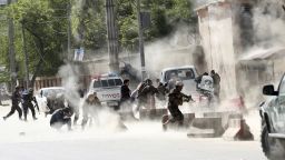 Security forces run from the site of an explosion in Kabul, Afghanistan,  April 30.