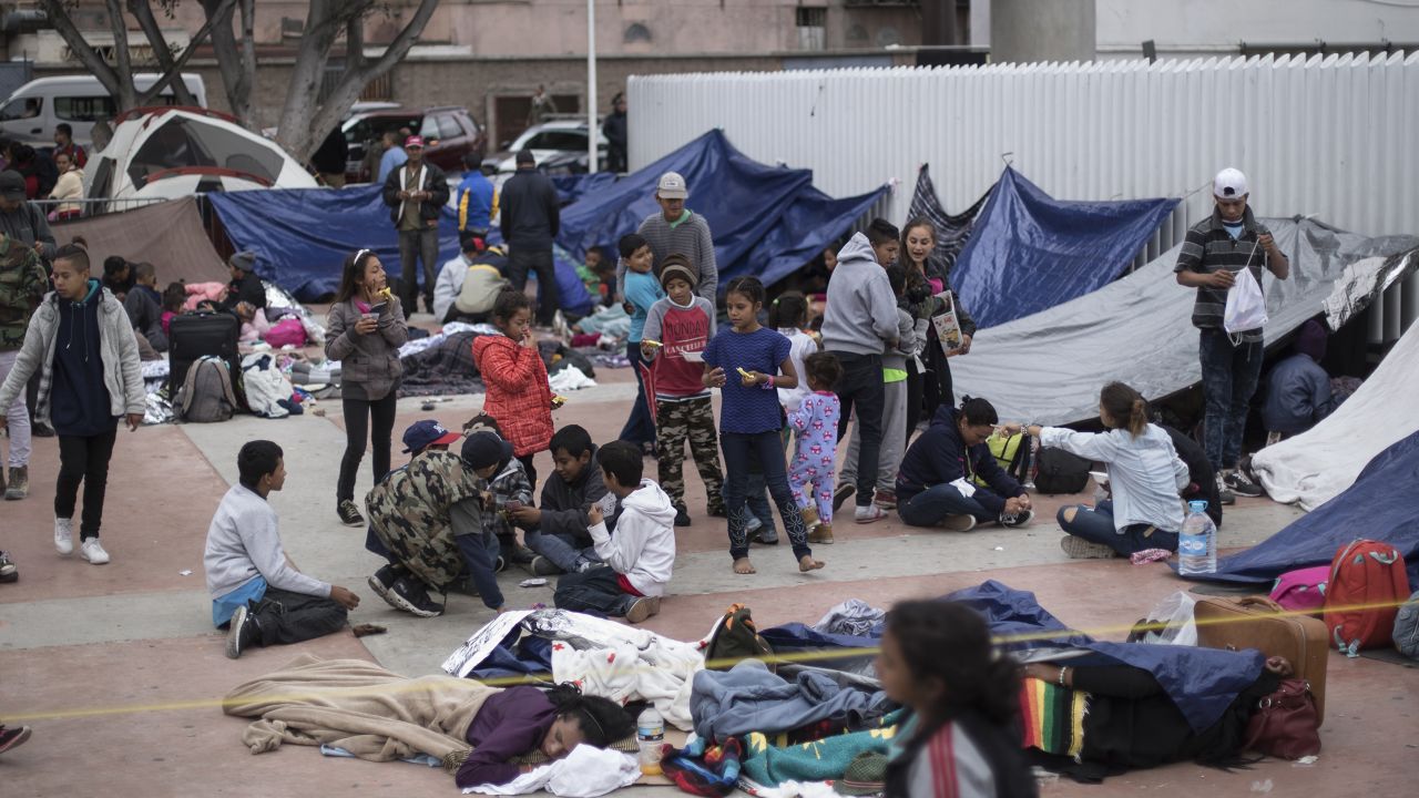 Migrants wait for access to request asylum in the US, at the El Chaparral port of Entry in Tijuana, Mexico, Monday, April 30, 2018. bout 200 people in a caravan of Central American asylum seekers waited on the Mexican border with San Diego for a second straight day on Monday to turn themselves in to U.S. border inspectors, who said the nation's busiest crossing facility did not have enough space to accommodate them. (AP Photo/Hans-Maximo Musielik)