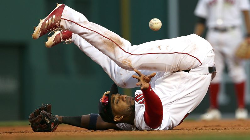 Boston second baseman Eduardo Nunez tries to throw the ball to first as he falls down on Saturday, April 28.