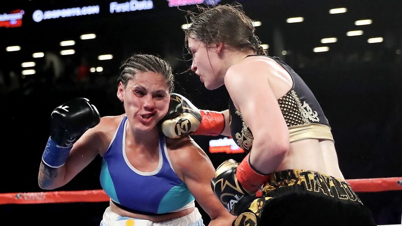 Katie Taylor punches Victoria Bustos during a lightweight title fight in New York on Saturday, April 28. Taylor won by unanimous decision, unifying the WBA and IBF titles.