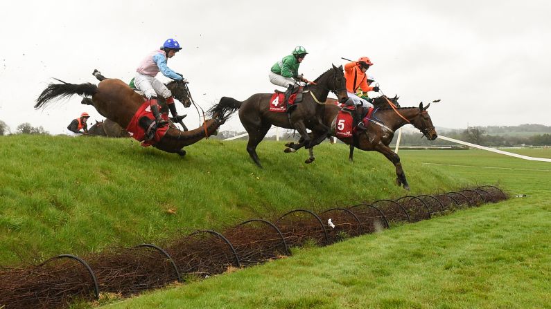 A horse falls during a steeplechase race in Naas, Ireland, on Tuesday, April 24.