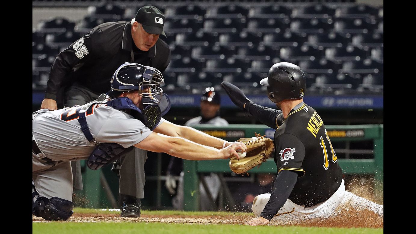 Pittsburgh's Jordy Mercer slides into home, avoiding the tag by Detroit's John Hicks on Wednesday, April 25. Pittsburgh won 8-3 in what was the second game of a doubleheader. Detroit won the first game 13-10.