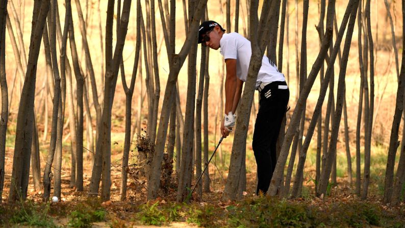 Micah Shin hits out of the trees during the second round of the China Open on Friday, April 27.