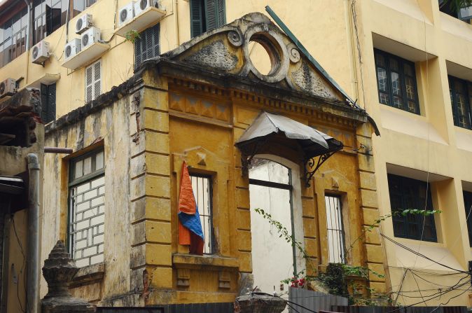 The gutted remains of a colonial-era villa next to a modern office building in downtown Hanoi.