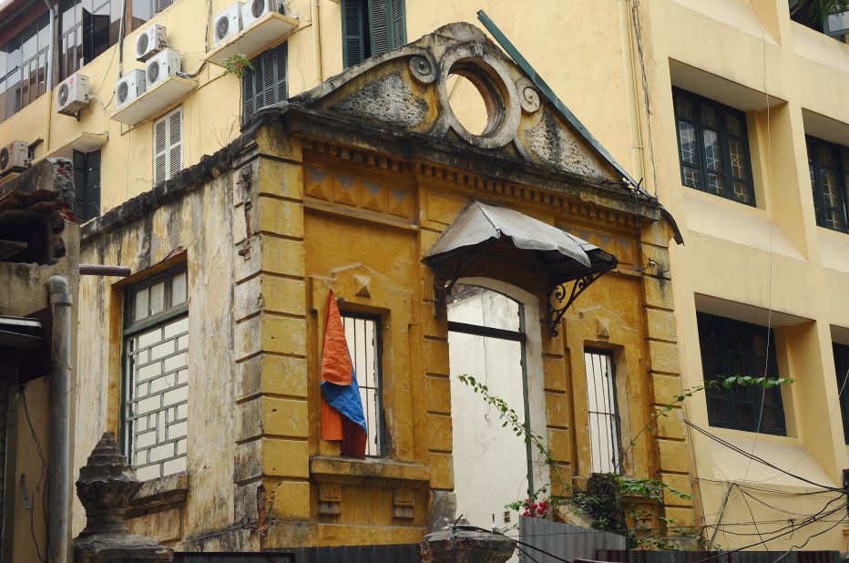The gutted remains of a colonial-era villa next to a modern office building in downtown Hanoi.