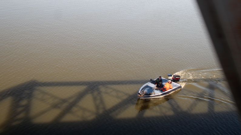 The train rolls through woods and over water and through cities on its way to New Orleans.