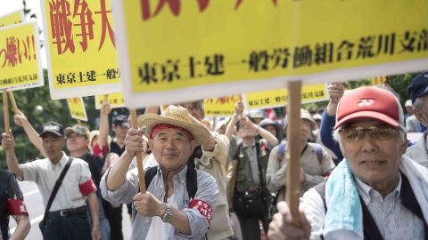 Workers hold placards at a rally organized by the Japanese Trade Union Confederation, in Tokyo. 