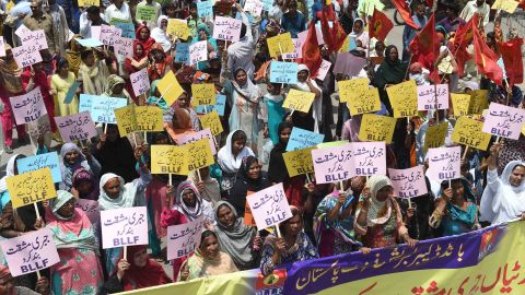 Union members hold placards during a march in Lahore, north-east Pakistan.