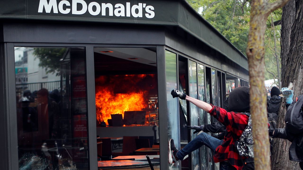 A McDonald's restaurant is hit with petrol bombs thrown by during the traditional May Day rally in the center of Paris.