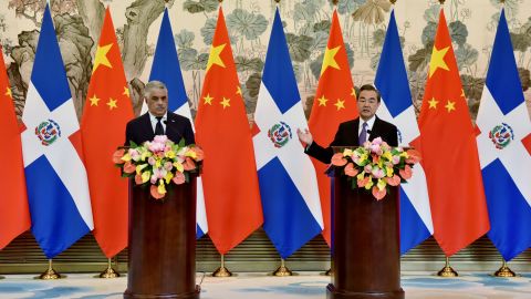 China's Foreign Minister Wang Yi, right, speaks after a signing ceremony with Dominican Republic Foreign Minister Miguel Vargas, left, after they  formally established relations.
