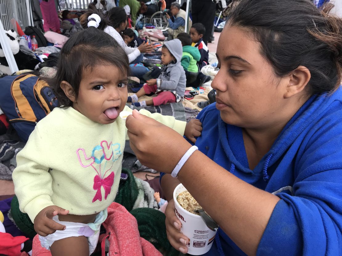 Catherine Enamorado feeds her daughter Ashly.