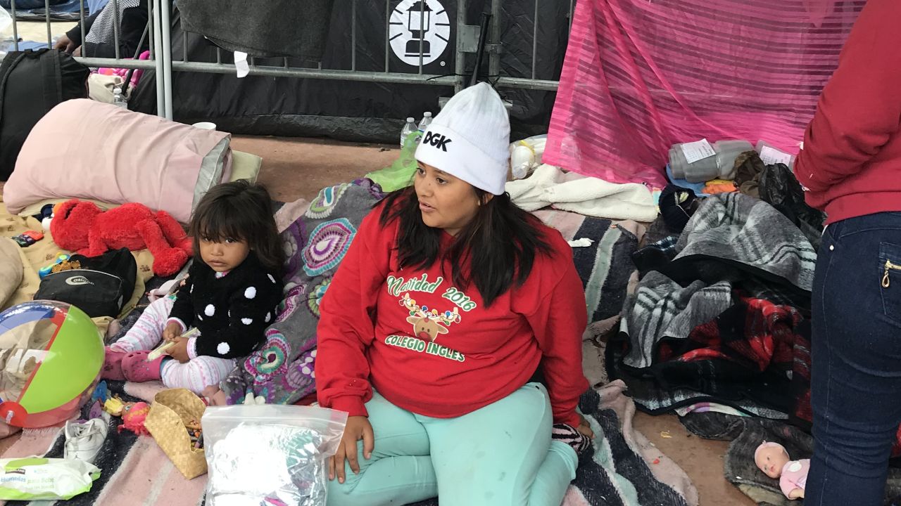 Sarae Carillo with her daughter Daryelen, 2, wait on the Mexican side of the border.