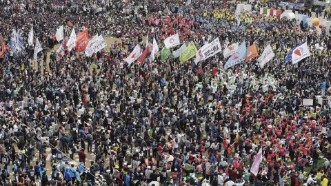 Members of the Korean Confederation of Trade Unions carry flags during a rally in Seoul.