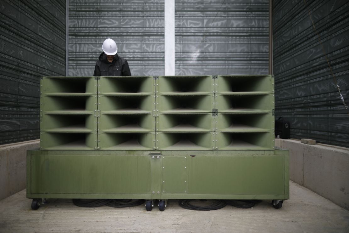 A worker dismantles the loudspeakers.