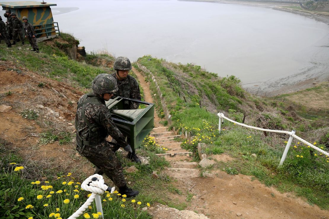 South Korean soldiers take down a propaganda loudspeakers on Tuesday.