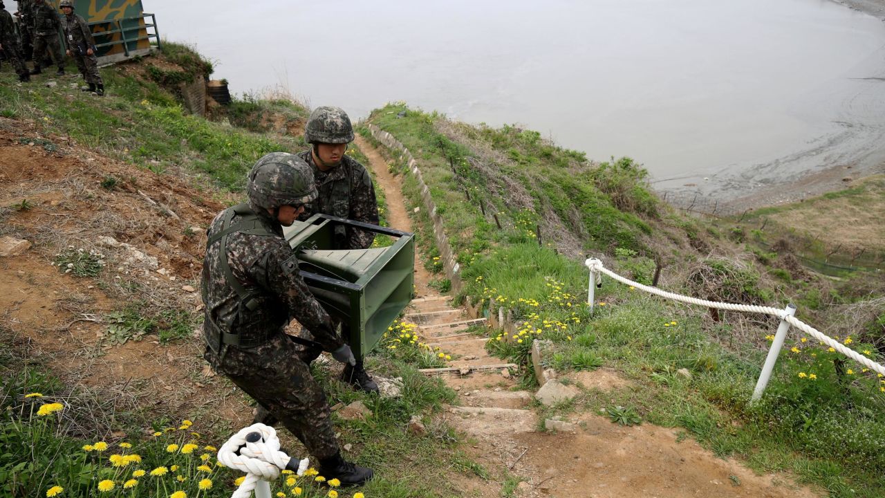 South Korean soldiers take down a propaganda loudspeakers on Tuesday.