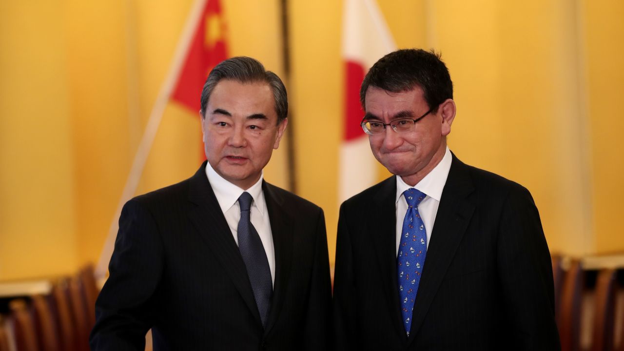 Japan's Foreign Minister Taro Kono (R) poses with his Chinese counterpart Wang Yi (L) at the start of their meeting in Tokyo on April 15.