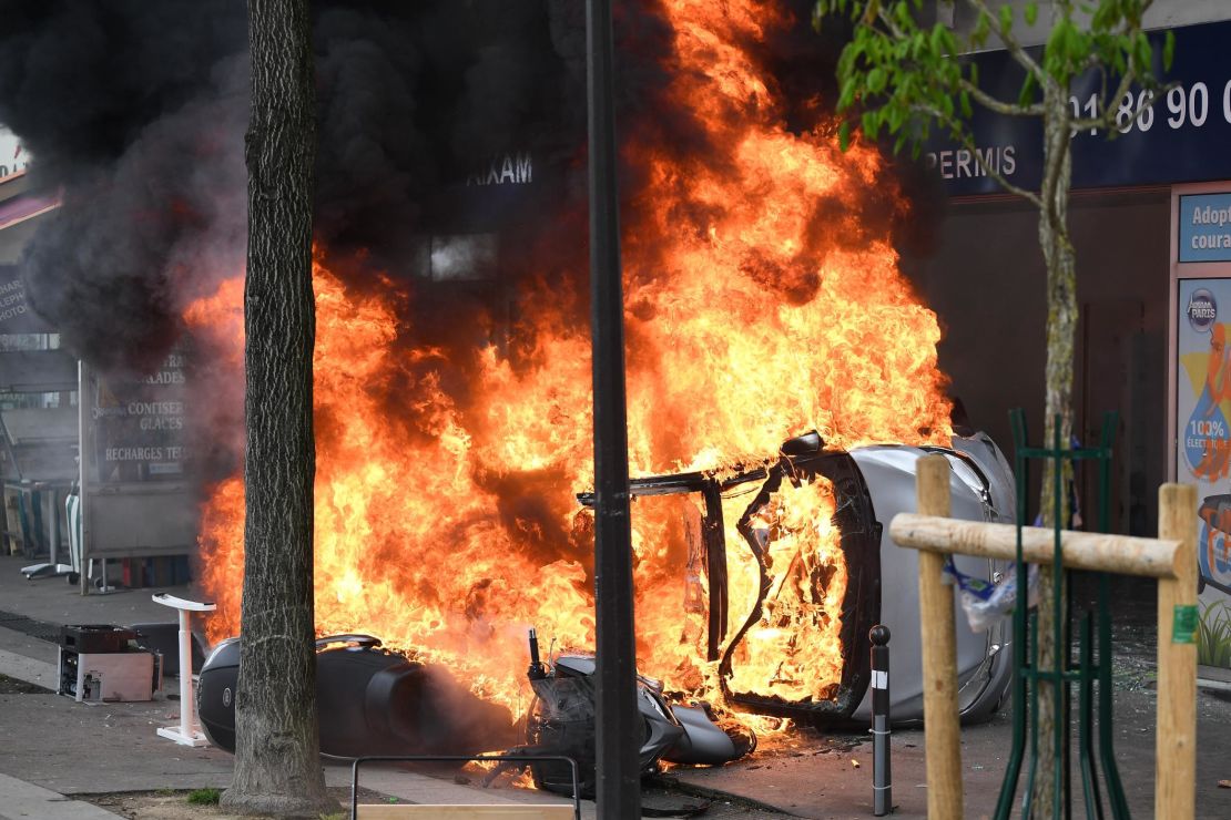 Vehicles burning as thousands of people take to the streets during the May Day demonstrations in Paris.