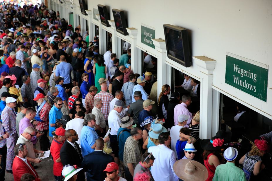 Punters prepare to place their bets at the wagering windows in 2014. 