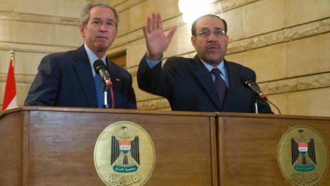 In a 2008 photo, Iraqi Prime Minister Nuri al-Maliki (R) tries to shield US President George W. Bush after an Iraqi man threw his shoes at Bush.