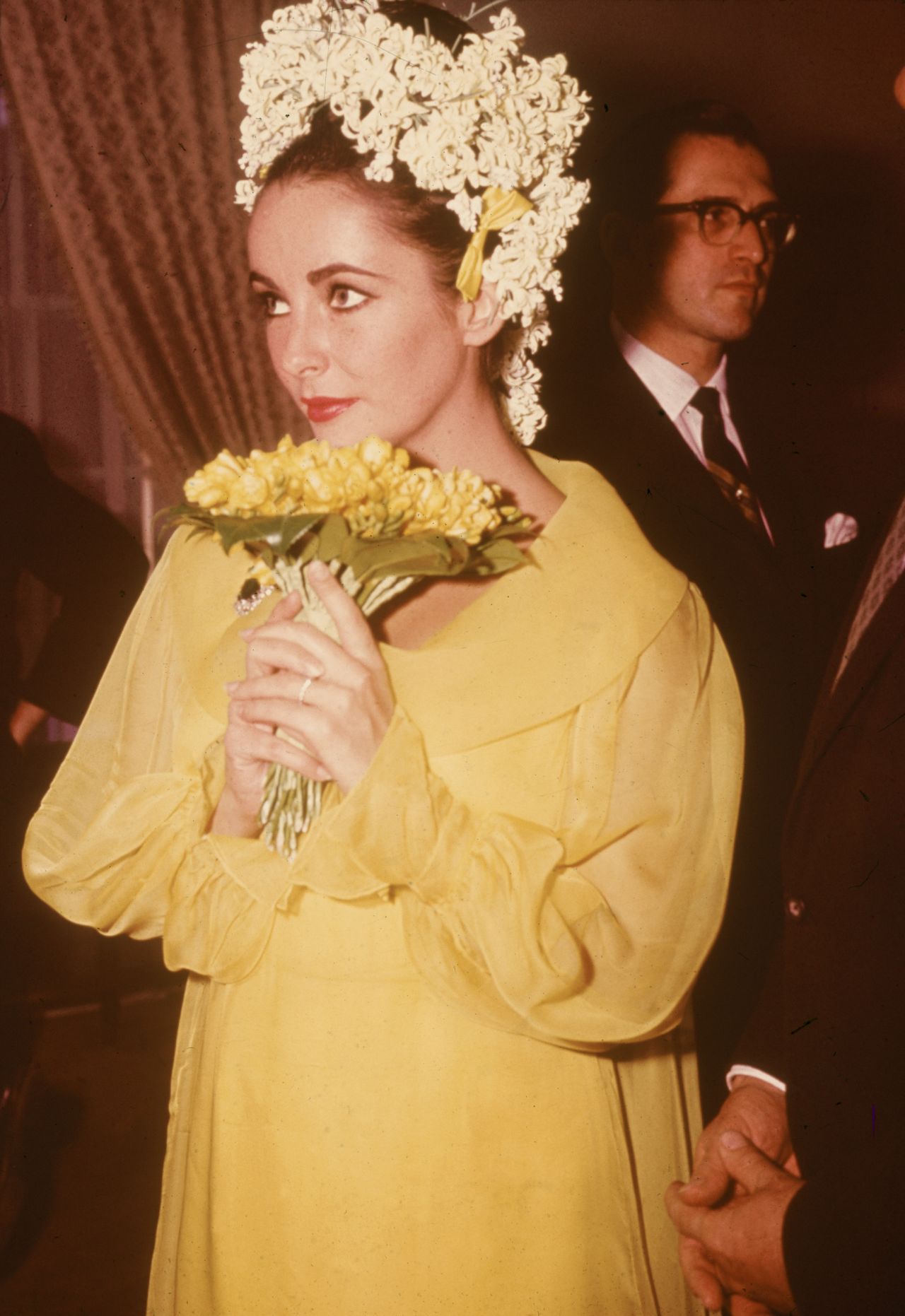 Elizabeth Taylor wore a striking yellow dress and floral headdress for her 1964 wedding to Richard Burton.