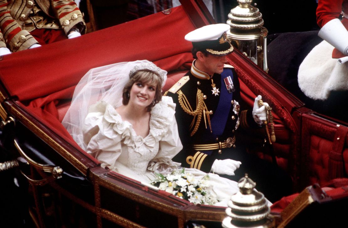 Prince Charles and Diana, who wears the Spencer family tiara, return to Buckingham Palace by carriage after their wedding in July 1981.