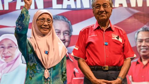 Wan Azizah, left, wife of jailed former opposition leader Anwar Ibrahim, gestures as former Malaysian Prime Minister Mahathir Mohamad, right, smiles during a rally ahead of the 14th general election in Malaysia's popular island of Langkawi.
