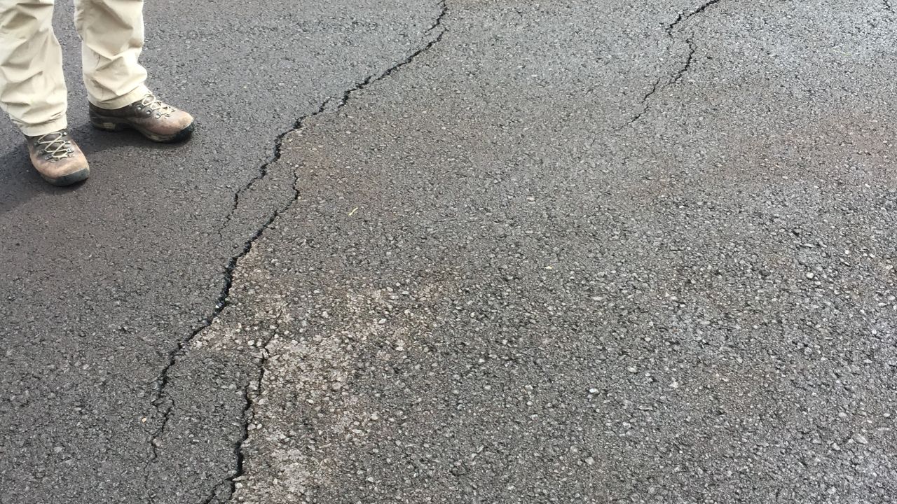 Small cracks are visible on roads in the Leilani Estates subdivision after quakes rattled the Big Island.
