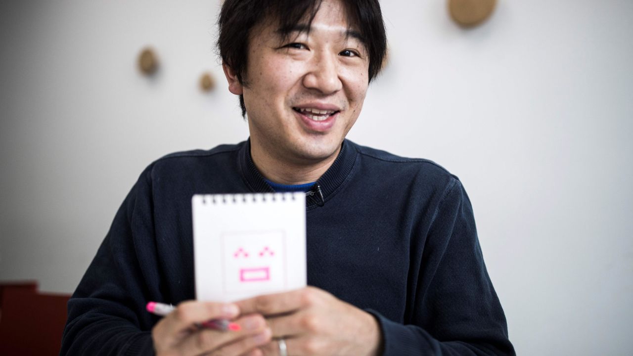 Japanese Shigetaka Kurita, the man who created emoji charachters, shows an emoji charachter after drawing during an interview with AFP in Tokyo on November 30, 2016.
Kurita was working at major telecom NTT Docomo in 1999 when he sketched out one of the first emoji, a clunky looking thing barely recognisable as the precursor to today's yellow smiley face. From a humble smiley face with a box mouth and inverted "V's" for eyes, crude weather symbols, and a rudimentary heart -- emoji have now exploded into the world's fastest-growing language. / AFP / Behrouz MEHRI / TO GO WITH AFP STORY: Japan-culture-computers, INTERVIEW by Miwa Suzuki and Anne Beade        (Photo credit should read BEHROUZ MEHRI/AFP/Getty Images)